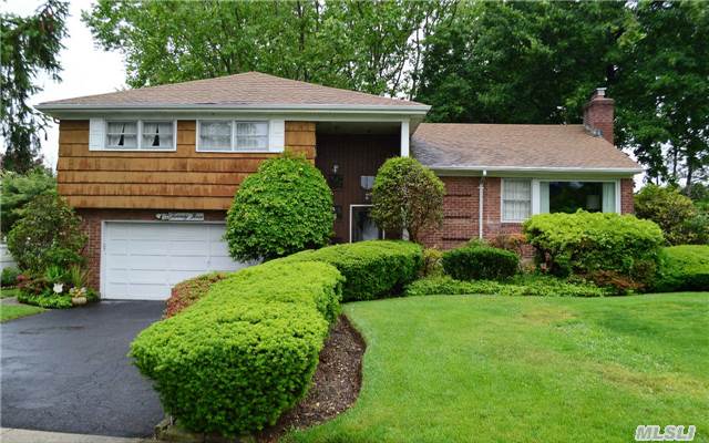 Spacious 3 Bedrm/2.5 Bath Split Level Home In The Flower Section Of Syosset. All Wood Floors, Updated Windows, Elect, Appliances & Utilities, Mid-Block Location, Att 2 Car Gar. Beautiful Flat Bkyd W/Patio & Lush Landscaping. Spacious Eik, Formal Dining Rm, Living Rm, Den & More. Syosset Sd.- Berry Hill Elem/South Woods Middle Schl. Taxes In Process Of Being Grieved!!