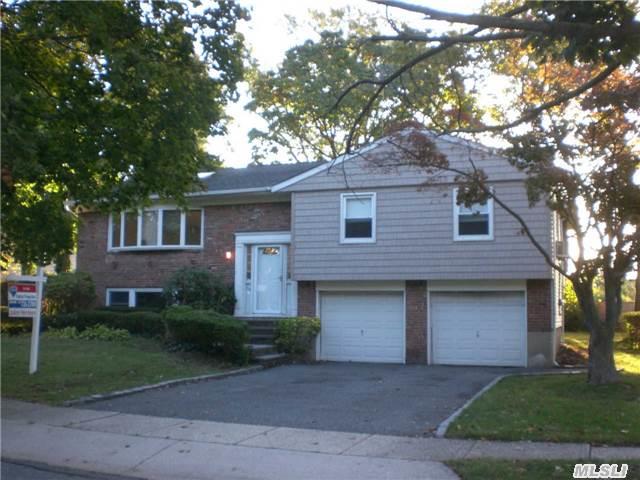 Four Bedroom Hi Ranch In Renowned Syosset School District Features Hardwood Floors, Sliders To Deck From Eik And Mbr, 2.5 Baths And Skylights. Lots Of Potential, Needs Some Updating.