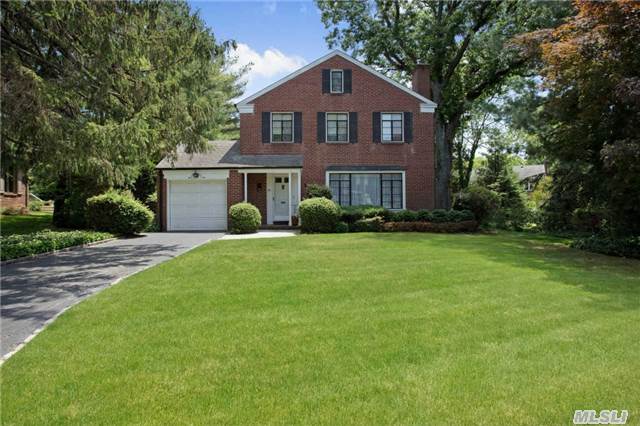 Beautiful Brick Colonial With Lovely Rear Garden In The Village Of Plandome Heights. First Floor Includes Living Room With Fireplace, Formal Dining Room, Eat-In Kitchen, Jalousie Porch And Guest Powder Room. Upstairs Features 3 Bedrooms And One Full Bath. One Car Garage. Beautiful Manicured Backyard Garden - Mid-Block Location - Convenient To Town And Lirr.