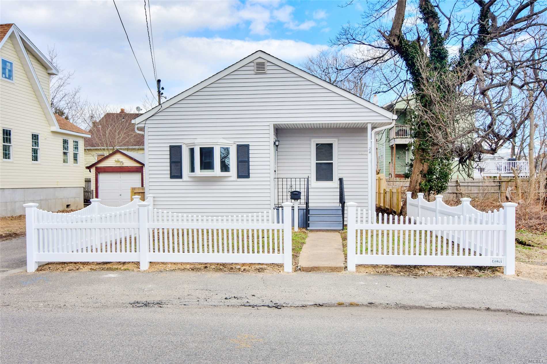 Bright and sunny 2 bedroom ranch home on a quaint beach street. New hardwood floors, newer windows and roof, easy living . Flood insurance required.