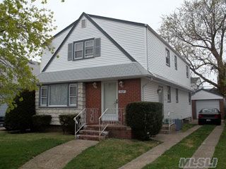 Outstanding Cape In New Hyde Park. Five Bedrooms. New Eat-In-Kitchen With Corian Counters. Stainless Steel Appliances With New Cherry Cabinets. Two New Baths. All Thermo Windows. Basement Has Family Room, Large Storage Room, Laundry And Utilities.  