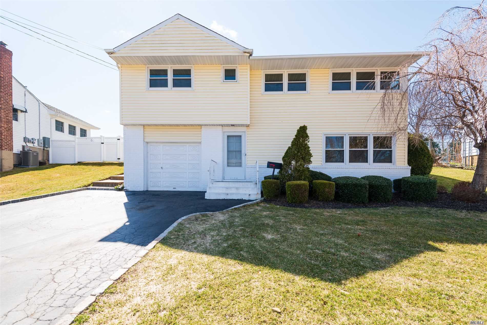 Updated Home With Very Nice Fenced In Yard. Syosset Schools. Very close to train and shops Village Elementary Southwoods Middle School GREAT PRICE REDUCTION!!!