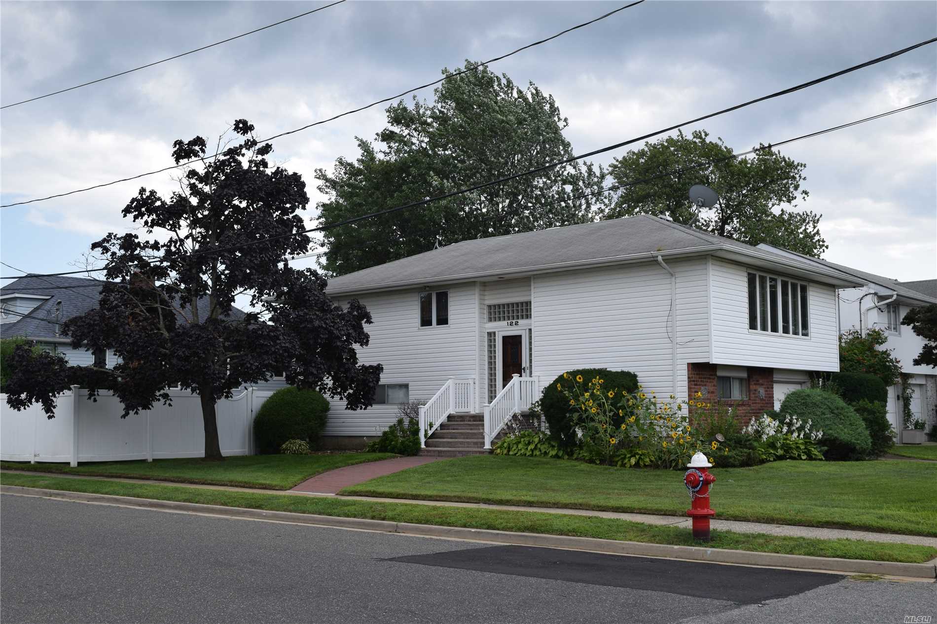 Beautiful Barnum Island Wide Line Hi Ranch. This House Features 3 Bdrms Bath Spacious Lr Dr Eik Wood Floors Thoughout . Ground Floor Has Bdrm Full Bath Huge Den W/ Sliders To Pvc Fenced In Yard. Utility And Laundry Room And Garage. Close To Lirr Town Of Hemp Shell Creek Park And Middle School. Low Flood Insurance... Make This House Your New Home!!!!