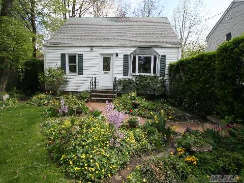 Charming Cape In Move In Condition Offers Incredible Gardens. Landscaped For Privacy This Pristine Home Features Lr W/Bay Window, Large Light Eik W/Door To Low Maintenance Deep Rear Property. 4 Br. 2 Baths. Full Basement. New Windows. Detached 1.5 Car Garage. Close To Shops & Lirr. A Winner!