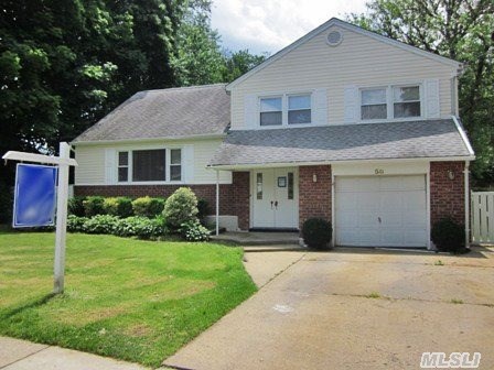 Move-In Ready Split In The Desirable Syosset School District! Centrally Located, Close To Public Transportation, Schools, Restaurants And More! Hardwood Flooring, Fireplace, Large Lot!