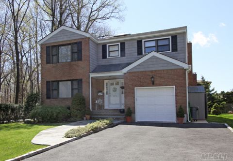 Located In The Manhasset School District, This Large Center Hall Colonial Built In 1987 Boasts Many Upgrades. This Home Features A  Large Living Room, Formal Dining Room, Eat-In-Kitchen, Family Room With Fireplace, Four Over Sized Bedrooms, Two Full Baths, A Powder Room, And Full Finished Basement.  Amenities Include An Alarm System,  Inground Sprinklers, Three Zone Heat