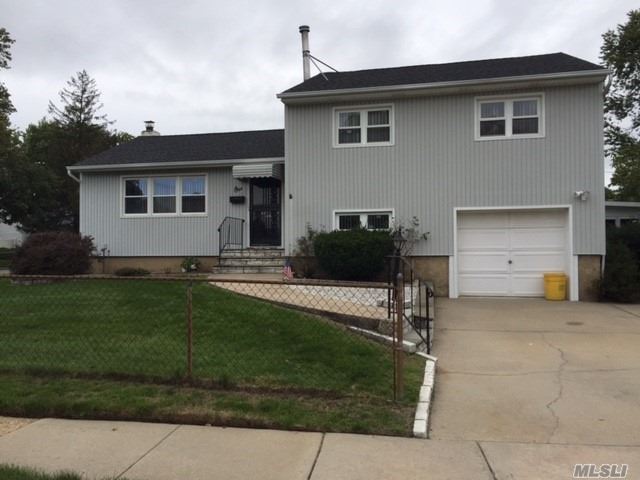 This Split Features Gleaming Hw Floors Under Carpet, Large Bedrooms, Gas Heating System, Large Corner Property With Sunroom, Large Living Area. A Must See!