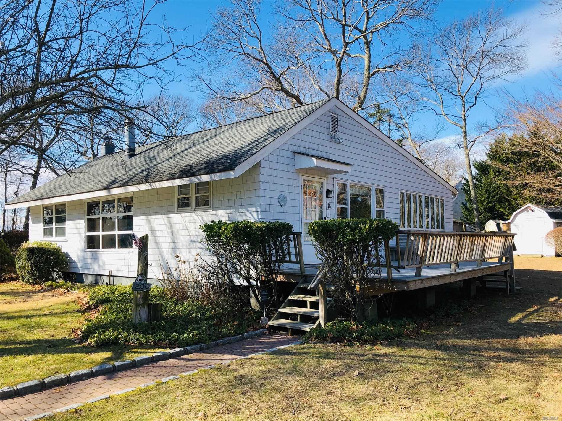 Perfect Location in Town! An Adorable Fixer Upper Full of Character and Awaiting Your Design. 2 Bedrooms and 1 Full Bath. A Fantastic Spot on a Quiet Street Overlooking the Private Golf Course in Laurel. Close to all the North Fork has to Offer
