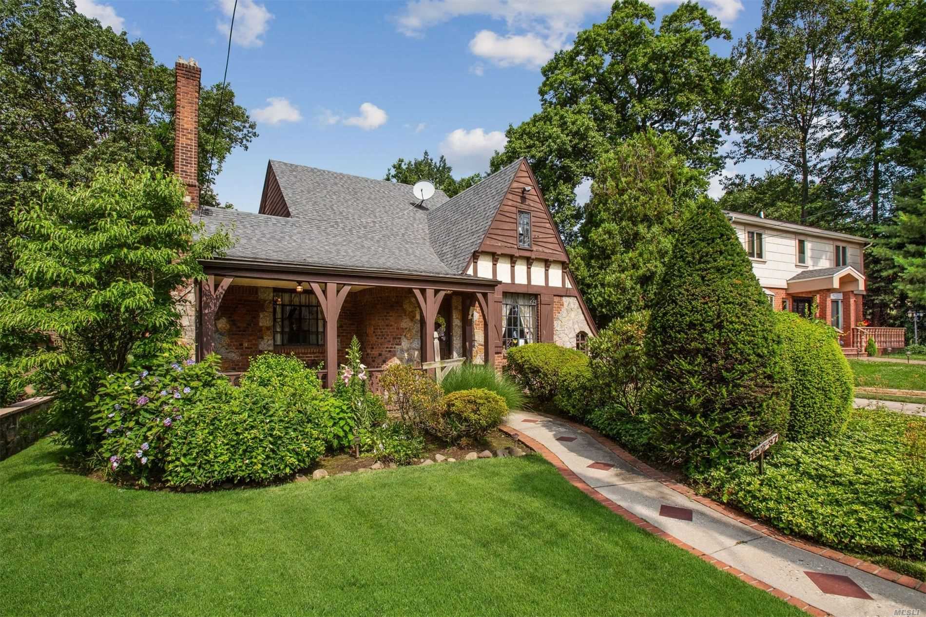 Charming Tudor in the heart of Jamaica Estates, Prime Location! This unique private piece of property features lots of original character & stained glass windows. New Kitchen w/granite counters. Over-sized 2 car garage. Mint wood floors. Updated baths. Convenient location, close to highways, shopping and houses of worship. Must See!