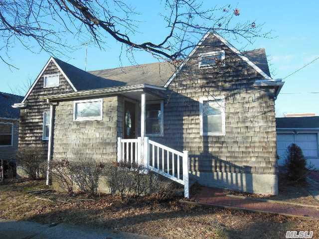 Spacious Cape Offering Three Bedrooms And Two Full Baths Charming Corner Lot. Partially Renovated Sandy Damaged Home With New Sheet Rock,  Wood Floors,  Bath,  Plumbing And Heat. Put Your Own Finishing Touches On This Very Affordable Home!