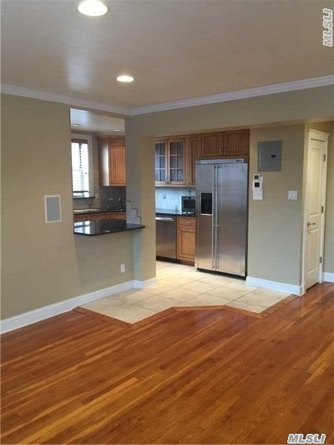 Total Renovation And Many Upgrades. Bright, Corner Unit, Open Kit, W/Granite Counters/ Bar And New Stainless Appliances. Large Living Room With Polished Hardwood Floors. Master Bedroom With Double Closet, In Closet Systems And Surround Sound. 1 Min Walk To Long Island Railroad, Near Restaurants, Shopping & Transportation.