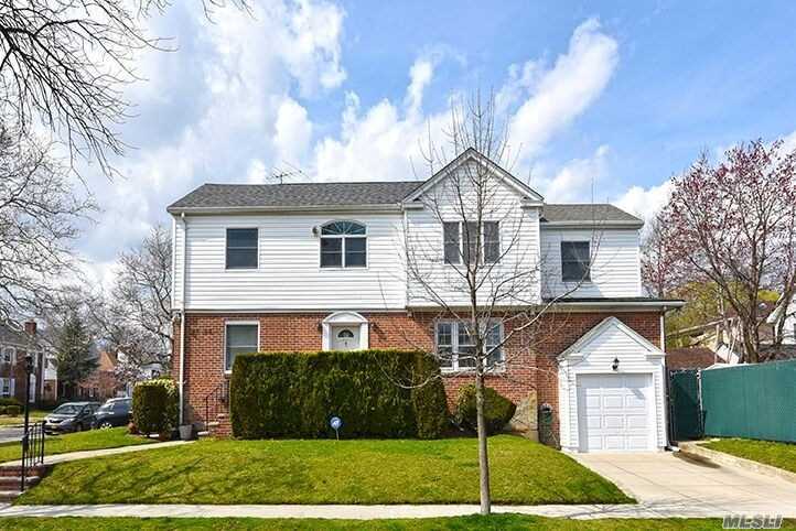 This Stylish expanded colonial sits on a well-manicured property in the heart of Fresh Meadows with proximity to all. A central hall entryway invites into a large entertaining living room which boasts a workable fireplace surrounded by wood bookcases. Mealtime is a breeze in this cheerful contemporary bright kitchen. Enjoy formal meals in the elegant dining room and relax in the adjacent den or outdoor patio. There is a full bath on first floor. Upstairs you will find 4 sunny large bedrooms.