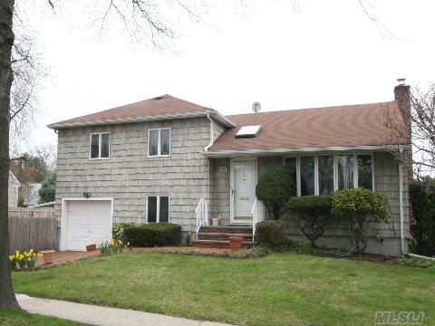 Lovely 3 Br 2 Full Bath Split Located On A Quiet Dead End Street, Short Walk To Guggenheim Elementary School. Side Hall Entrance With Sun Drenched Living Room That Opens To Dining Room And Eik. Step Down To Famiy Room With Full Bath, Mud Room And Attached Garage, Full Basement With Cedar Closet, New Windows, Central Station Alarm, Cac, Fenced Side Yard