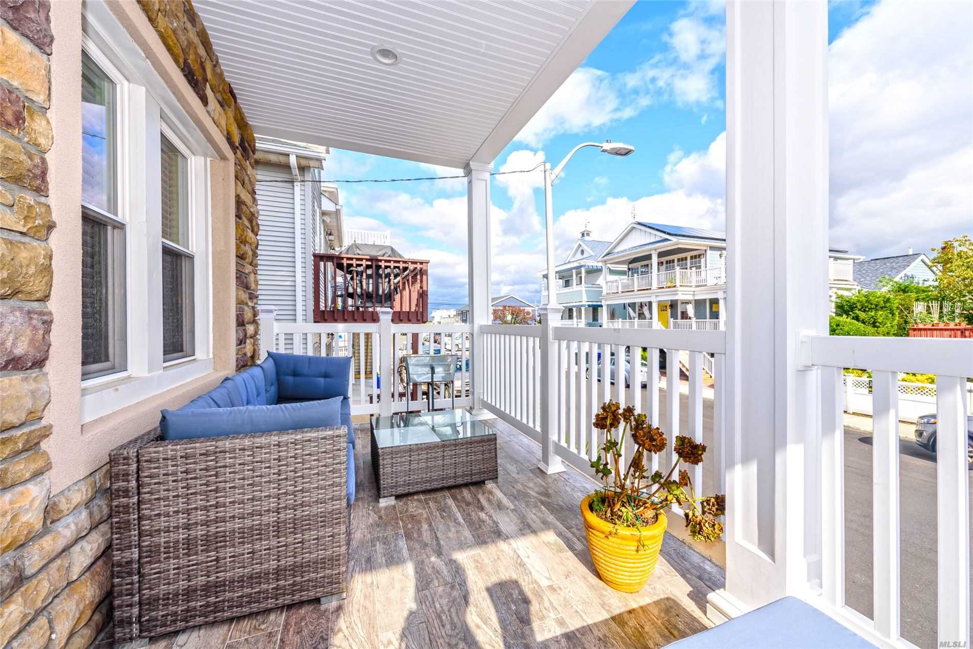 Impeccably Renovated FEMA Compliant Wide Block Stunner! Open Layout W/Gorgeous Hw Floors & Crown Molding Throughout: Living Room W/Cozy Gas Fireplace, Dining Area, Kitchen W/Ss Appliances & Granite Counters & Island, 2 Bedrooms. 3rd Floor Master Ensuite W/Huge Walk In Closet & Full Bath & 1 Car Garage. Enjoy Bay Views From Upper Deck & Front Porch! New Garage Door, Anderson Windows, Chimney, A/C System. The List Goes ON! Flood Insurance: $504.00