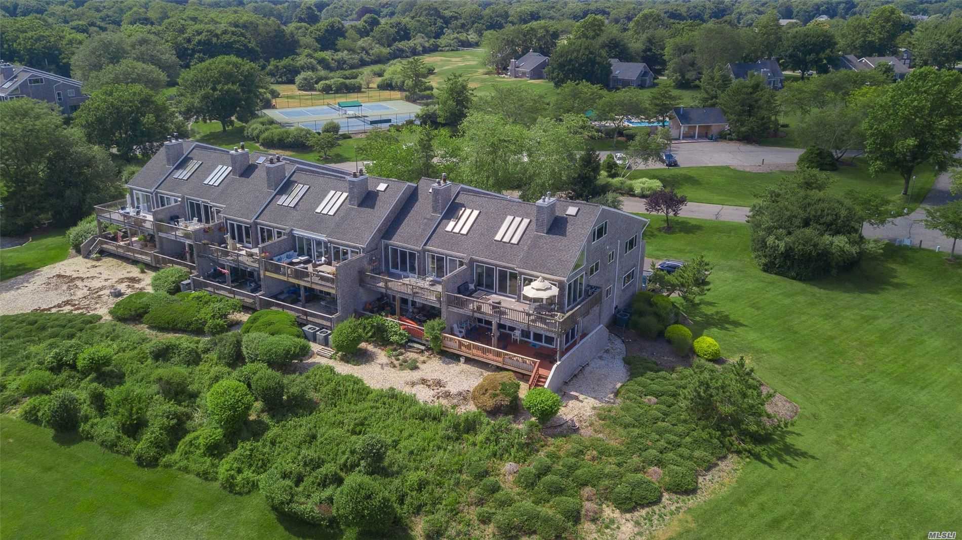 Elegant, Stunning, and Gorgeous UPPER END UNIT in Sought after Harts Cove! Breathtaking Views of Moriches Bay, 2 Ponds with Nature Watching Galore, & the endless Sky! Radiant Heated Floors, Magnificent Stone Fireplace, Custom Baths & Tile work throughout, Exquisite lighting & High End Kitchen! Wine Cellar is truly an artisan Crafted find! Heated Pool, Boat Slip, Horses & Tennis - What More would you Want or Need to Call Home? Be Careful what you Wish For - You Will Fall In Love!