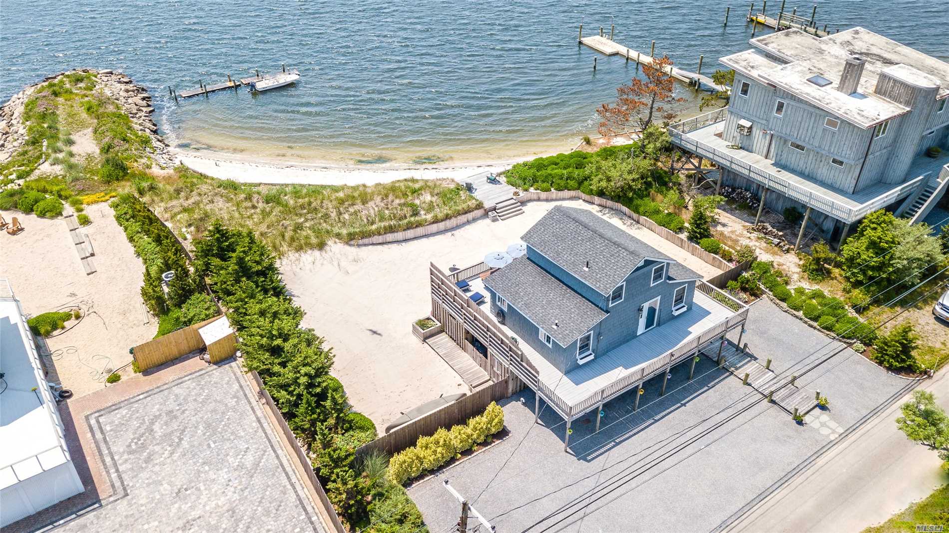 Spectacular Describes The Views & Location Of This Beach House. Overlook The Inlet & Robert Moses Bridge From Your Wrap Around Deck. Put Your Toes In The Sand Of Your Own Beach. Dock Your Boat At Your Own Floating Dock Property Has A Retaining Wall Around Perimeter And A Jetty Off The Beach. This Is A Gated Community On The East End Of Oak Beach It Features Large Property And Reasonable Taxes. Year Round Living In Paradise !!