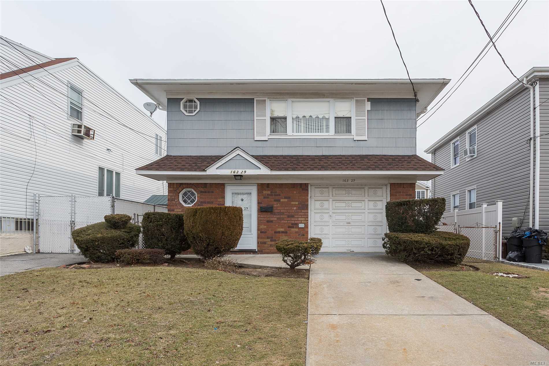Great Potential House In The Heart Of Howard Beach Use As A Mother-Daughter, 1st Floor Recently Updated Features 2 Bedrooms, California Kitchen, New Roof, New Water Tank, Boiler Only 5 Years Old, Central Heat, Spacious Bedrooms,  Heated Garage. Nice Backyard Great For Entertainment.  Must See To Appreciate It.