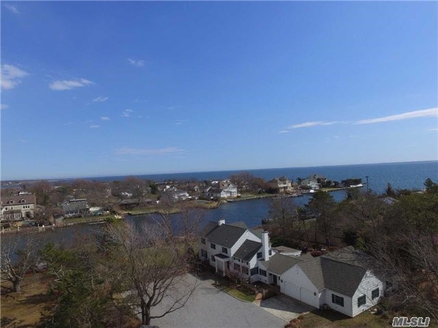 Bayberry Point Classic On 1.20 Acre Waterfront Parcel On Enormous Middle Canal. Every Inch Of This 3500 +/- Sq. Ft. Home, Plus 1534 Sq. Ft Garage Is Pristine. Aggressive List Price Reflects Necessity To Replace Bulkhead. D.E.C. Permits Included By Seller.