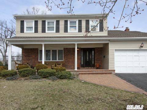 An Open Air Country Porch Welcomes You As You Enter This Rare Side Hall Syosset Colonial. It Boasts A Dark Cherry Kitchen With Newer Appliances Overlooking The Family Room Which Includes A Wood Burning Fpl & Sliding Glass Doors, Leading Out Towards Your Outdoor Entertaining Area.