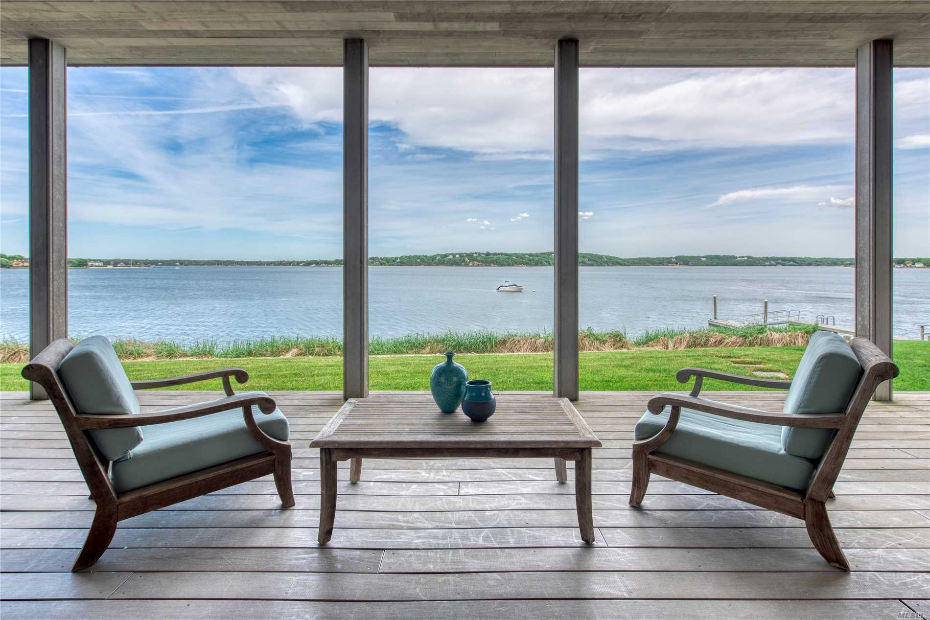 Peaceful Perfection on Peconic Bay. This Open Concept Contemporary Treasure Reflects Simplicity in Design at its Finest.  Stunning Views of Shelter Island Welcome You as You Enter the Great Room Foyer. Clean Lines and Minimalist Architecture with Attention to Detail at Every Turn Creating a Unique and Tranquil Living Experience. Come Discover Serenity.