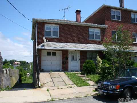 Semi-Detached Brick Two Family With Spectacular Water Views Of Powells Cove, Malba, And The Whitestone Bridge. Five Rooms Over Four Rooms And A Walk-Out Basement. Each Floor Has A Fireplace. Home Has Two Driveways Side By Side And A Garage.