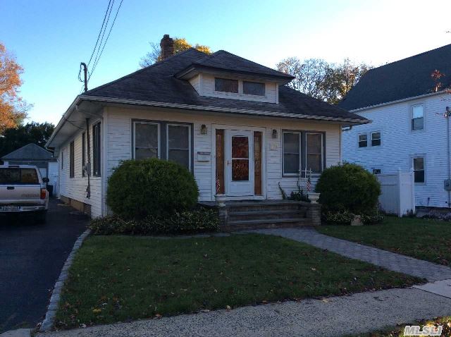 Make This Cozy House Your Home! Wonderful High Ceilings And Classic Moldings. Large Eik W/Gas Cooking. Large Walk-Up Attic You Can Finish For More Living Space Or Bedrooms. Finished Basement W/New Carpet. Outside,  Above Ground Oil Tank. Freshly Painted Interior,  Laundry Room Off Kitchen. Near Shopping,  Buses And Lirr.