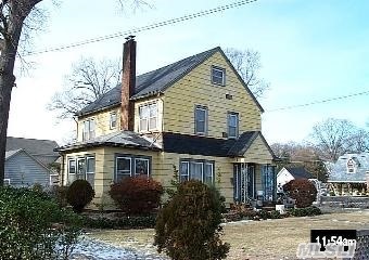 Located Between Sunrise Highway & Seaman Avenue. 8 Room Colonial On 100X125 Lot Offers 2,282 Sq Ft With 4 Bedrooms 1.5 Baths Lr With Fireplace Fdr Family Room Hardwood Floors Throughout Fireplace 2 Car Detached Garage Plus Full Unfinished Basement.