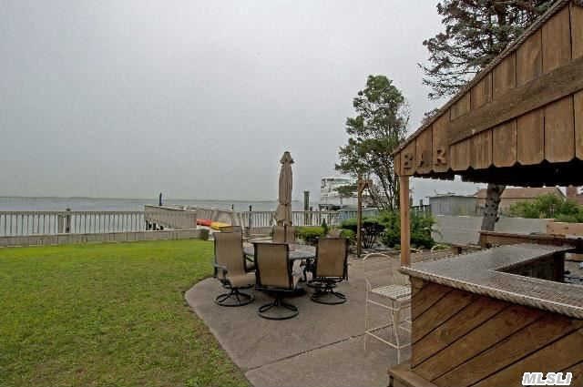 Exquisite Bay Front Home With Amazing Water Views. This Sprawling 4600+ Sq.Ft. Residence Features A Gourmet Kitchen With Custom Cherry Cabinets, Beautiful Granite & Modern Ss Appliances, Waterfront Livingroom With Fireplace & Wet Bar, H/W Floors, Renovated Bathroom, 3 Car Attached Garage + Driveway 3-4 Cars. Spectacular Backyard With A 61' Deep Dock, Bar & Japanese Garden