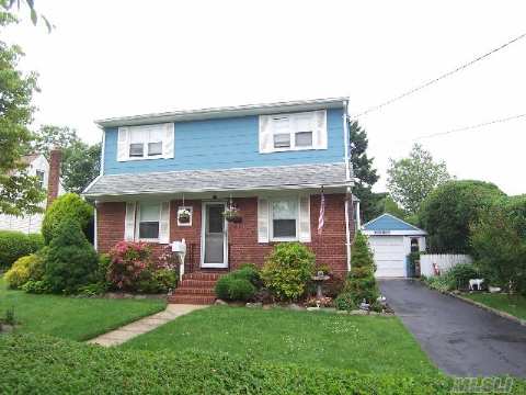 Nestled Away In The Middle Of The Block Is This Extended Colonial W/Charming Full-Walled Brick Fireplace. Just Some Updates Include Windows, Ugs, Heating System, Laundry Shoot, Skylights, Granite Countertops, Hardwood Flrs And More. Gas Heating And Cooking As Well. Beautiful Curb Appeal. A Must See!!!!! 