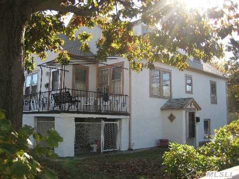 Legal Two-Family Stucco House On Large Corner Property With 2-Car Detached Garage & 2 Back Patios. First Floor Is A 1-Bedroom Apartment. Upstairs Is A Duplex With 3 Bedrooms & 2 Baths.