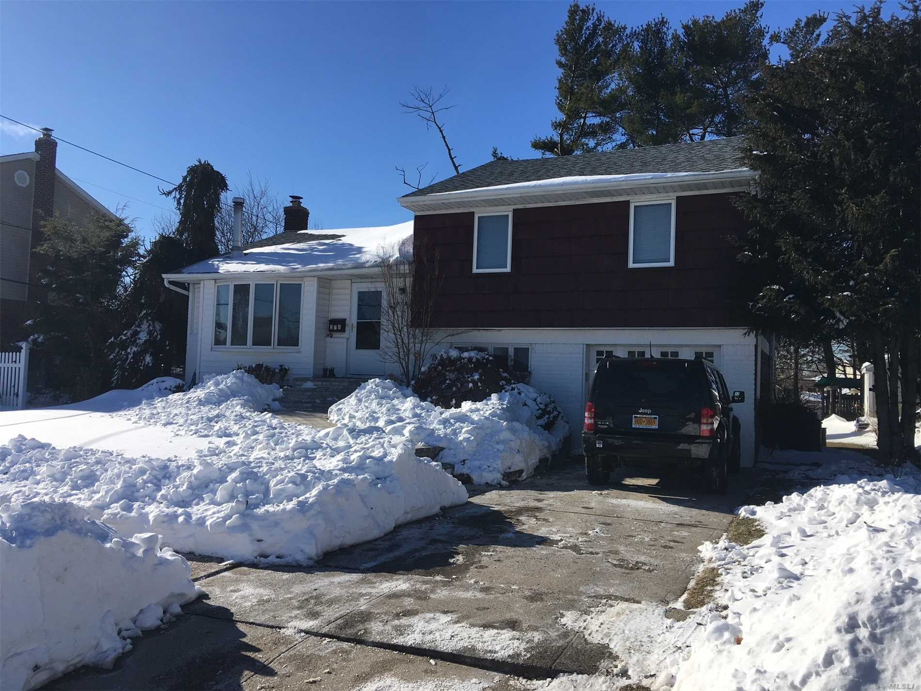 Lovely Updated Split Level In Prime Syosset Neighborhood. Newer Kitchen W/Stainless Appliances, Dramatic Skylight In Lr, Wood Floors Throughout, Finished Basement, Central Air, Rear Deck, Mid Blk Location , Lawn Sprinklers, Large Property,  Wood Stove May Be Removed, Hot Tub As Is.