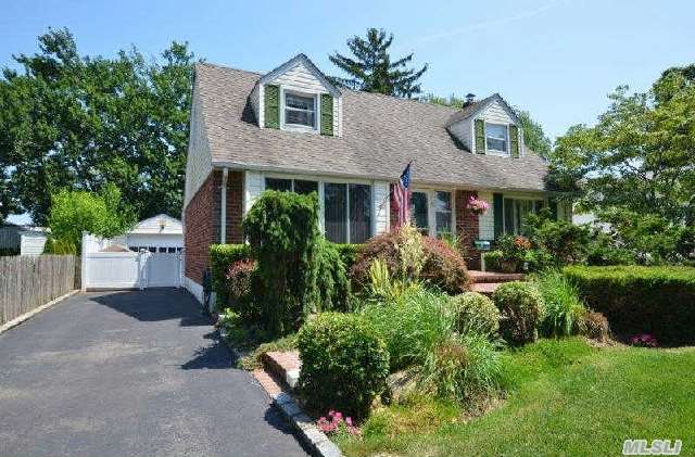 Spectacular 3/4 Bedroom Center Hall Cape With Specimen Plantings And Great Curb Appeal. Large Dining Room Was Once The 4th Bedroom And Can Be Converted Back. Large Entertaining Rooms,  Updated Kitchen & Baths,  Cac,  Master Has Large Walk In Closet,   Gleaming Hardwood Flooring,  Detached 1.5 Car Garage,  Private Fenced And Landscaped Yard. Gas In Street For Easy Conversion!