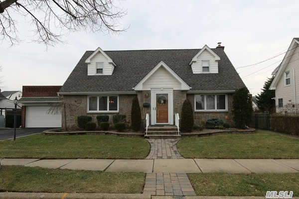 Magnificent Wideline Brick And Fieldstone Cape On A Fantastic 75 X 100 Lot.  First Floor Features A Living Room,  Formal Dining Room,  Eat-In Kitchen,  Two Bedrooms,  Full Bathroom And A Family Room. Second Floor There Are Two Huge Bedrooms And Full Bathroom.  House Is Rear Dormered.  The Basement Has An Outside Entrance.  Rear Patio Right Next To The Oversized Garage.  There