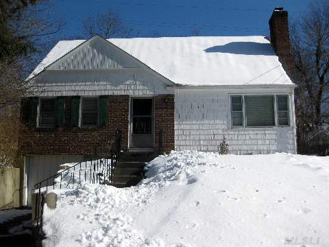 Brick & Shingle Center Entrance Cape With Oak Floors.Lr/Fp;D.R.;Kitchen;Full Bath;2 Bedrooms. L-Car Garage.  Partially Fin. Basement With Separate Laundry Area. Unfinished Second Floor With Plumbing For Heat & Bathroom.  L/2 Mi. To Lirr & Town. 