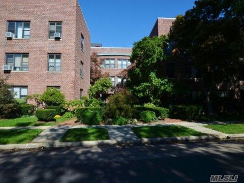 Spacious 2Br, 1 Bath Corner Unit On 1st Floor With Eik, Dining Area, Large Lr W/Ouside Entrance To Private Patio, Generous Closets & Hw Parquet Floors Throughout. Convenient To Town, Lirr, & Grace Ave Park. Choice N Or S Hs. Super On Premises 24/7. Wait List For Parking & Storage Unit.