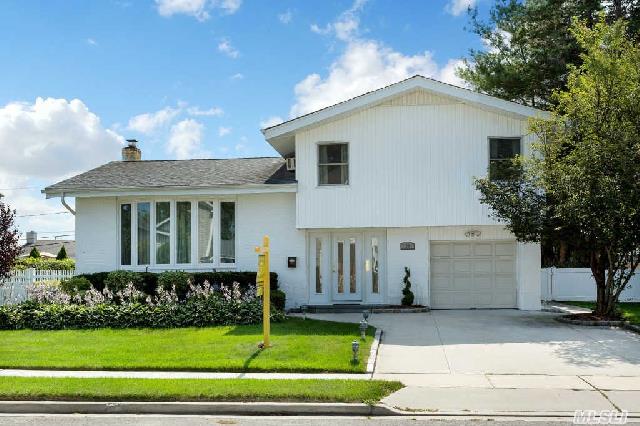 Lovely Updated Split In Move-In-Condition, Entry Foyer Overlooking Family Rm, Lite Wood Kitchen/Granite Counter/Ceramic Flr, Cath Lr, New Bay Window Lr(Energy Efficient), Stained Flrs Throughout, Main Bth W/Granite Counter/Jacuzzi Tub, New Hw Htr, Swing Set Inc, Beautiful Parklike Yard, Near Shops, Highways & Minutes From The Lirr.