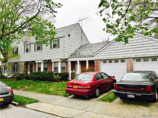 Charming Center Hall Colonial House Situated On A 40 X 119 Lot. Home Hosts 4 Bedrooms 3 Full Baths With A Bedroom And Bath On The Main Floor. Eat In Kitchen, Hardwood Floors , 2 Car Garage. Conveniently Located Close To E, F Trains, Buses, And House Of Worships. District 26!!!!!!!!