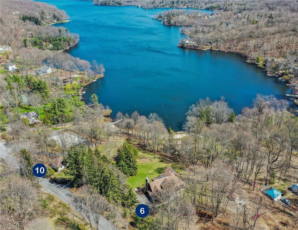 Escape to this lakeside estate with 2 homes on 3.26 acres.