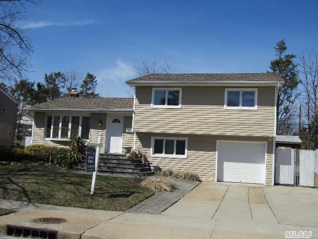 Mid Block Updated  Split Level W Vaulted Ceiling Living Room,  Updated Eat In Kitchen,  Bathroom W Whirlpool Tub,  Steam Shower And 2 Skylights,  Newer Windows,  Central Air,  Vinyl Siding,  Hi Hats Throughout,  Alarm System,  Paving Stone Driveway,  New Garage Door.