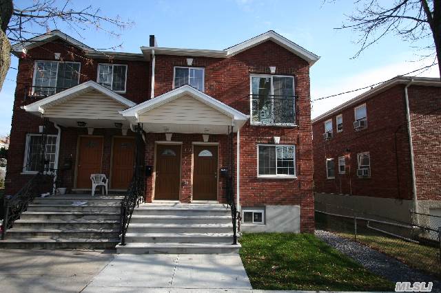 Brick Two Family Home Features Two - Two Bedroom - One Bath Apartments And A Finished Basement. No Driveway.