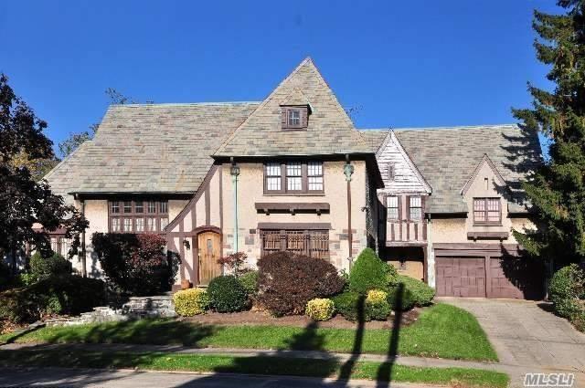 One-of-a-king English Tudor mansion in historic Jamaica Estates On A Beautiful Tree-lined Street . Breath-taking cathedral ceiling 20 Ft with Fireplace, Hard wood Floors, Custom Built library on second-floor overlooking the living room. Highest-quality huge stained-glass custom made windows unique to this home. Separate Breakfast room & Large Renovated kitchen with Granite island and restaurant-quality stove And Stainless Steel Appliances. Computer Room. 2 Separate Entrances to the second floor.