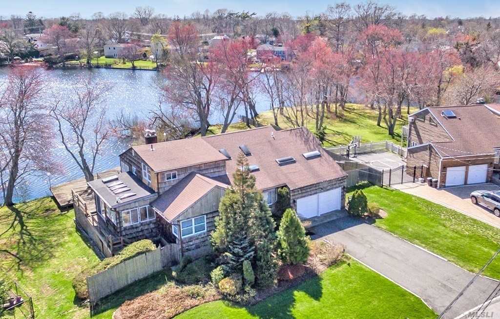 Beautiful Location For This Split W/ Full Bsmt. Home Sits W/ Panoramic Views Of Lake Capri In Your Back Yard. Relax In Your Yard With Peaceful And Tranquil Views. Master Bdrm Has Wonderful Views, And Loft Overlooks Huge Living Room. Taxes are being grieved by the homeowner