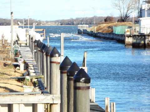 Waterfront At A Great Price! Home Stuated On A Bulkheaded Canal Leading Out To The Peconic Bay. This 4 Bedroom, 2 Bath 2 Story With Enclosed Sunroom And 1 Car Garage. 450 Ft From The Peconic Bay.