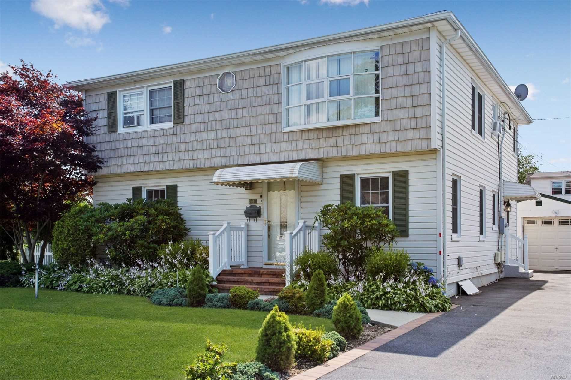 Expanded 10 room Cape, with 2 Living Rooms, 2 Eat In Kitchens, 4 Bedrooms, 2 baths, Perfect Mother Daughter with Proper Permits. Manicured Private Yard. With Plenty Of Street Parking. Close To Lirr, Buses And All Shopping. Centrally Located To All Highways, Parkways.