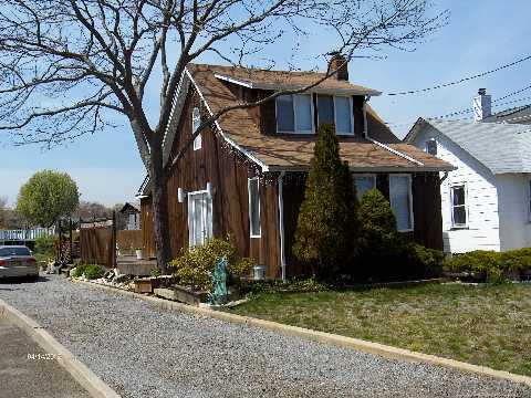 A Little Loving Care Needed For This 1928 Waterfront Cottage.  Serene Setting On Large Property With Wonderful Water Views, Fireplace In Living Room, Deck Off Of Kitchen, Second Floor Lofted Bedroom, Hardwood Floors, Updated Windows, Floating Dock With 60 Amp Electric, Storage Shed. Taxes Do Not Include Star Savings Of $1245.11