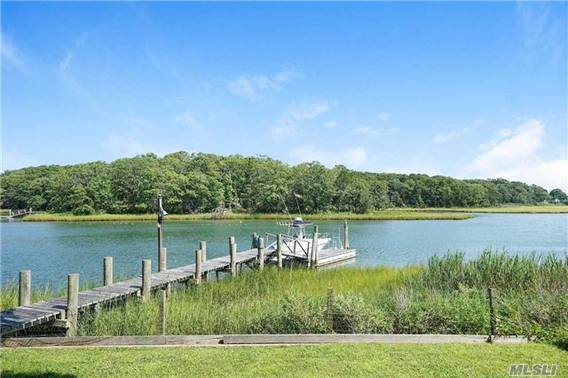 Boaters Paradise! Charming Waterfront Home With Panoramic Water Views From Every Room! Big Deep-Water Dock With Access To Peconic Bay. New Kitchen And Baths. Amazing Stone Fireplace. Central Air. On Demand Water Heater. Short Stroll To Sandy Beach.