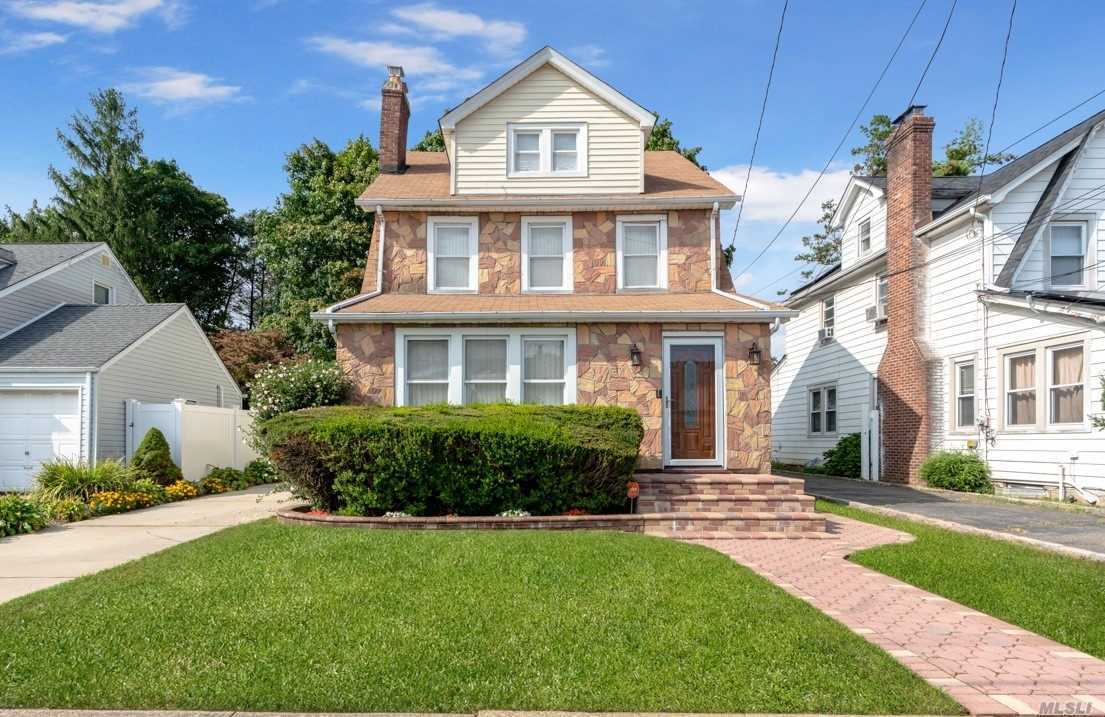 This elegant Colonial home features large LR, spacious DR, cozy den & additional office space. Gorgeous HW floors on 1st fl., renovated kit w/SS appliances & sliding glass door to lovely deck & pvt backyard. 2nd floor has 3 bedrooms, with the smallest bedroom being used as a walk-in closet. But with additional rooms in the walk-up attic, & a finished basement, there is room to spare.Gas heat, updated electrical, security system, long private driveway, 2 car garage & ingrnd sprnklrs- This home is a GEM!!