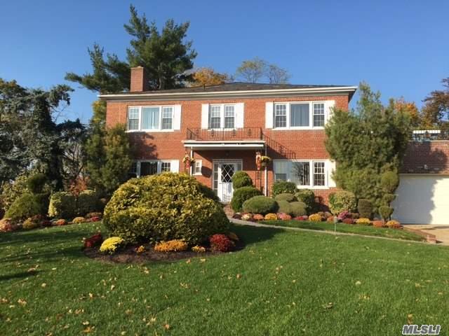 Full Brick Center Hall Colonial Situated On Quiet Private Tree Lined Street, Spacious Rooms, Two Car Garage, 2 Heating Zones, New Windows, Loaded With Sunshine, Sliders To Backyard From Walkout Basement, Balcony On Second Floor