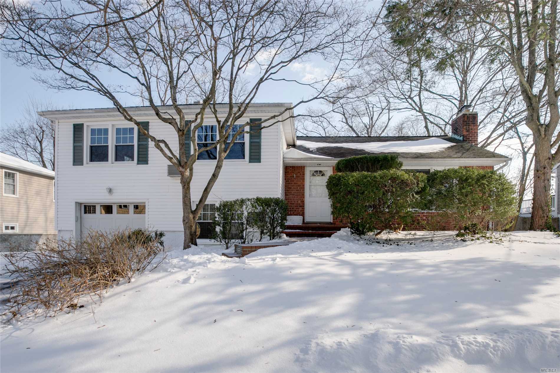 Pristine Split Level Home, Freshly Painted & W/Beautiful Hardwood Floors, Updated Windows & Roof. Custom Ipe Wood Deck, Oversized Flat Back Yard. Eik W/Island. Dr Adjoins Lr W/Fplc & Windows Across The Front Of House. 3 Spacious Brs/2 Full Baths. Walk-Up Attic Offers Great Storage & Opportunity For Expansion. 1-Car Garage At Grade, W/Fr, Office & .5Ba. Unfin Bsmt W/Laundry