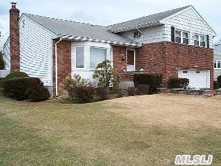 Nice Size Brick Split Centrally Located In Fantastic Neighborhood. Close To Park, Golfing, Seaford Oyster Bay Expressway! 2 Car Garage, 3 Full Baths, Sunken Lr! Newer Roof! Don't Miss The Opportunity To Live In This Area!